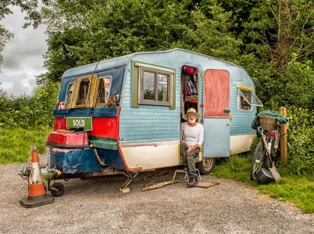 Photo Of A Man In White Long-sleeved Top on Blue And White Pop-up Camper