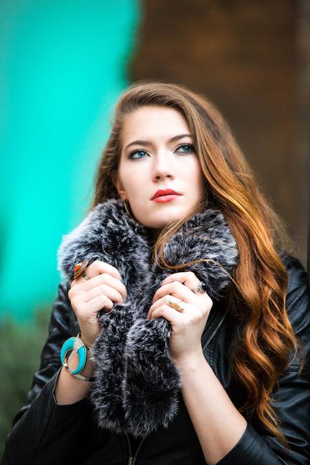 Photo of a Woman Holding Her Black Furry Scarf