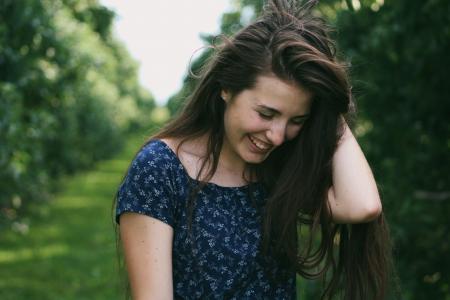 Photo of a Woman Holding Her Hair