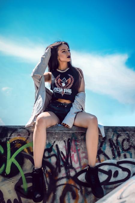 Photo of a Woman Sitting on a Ledge