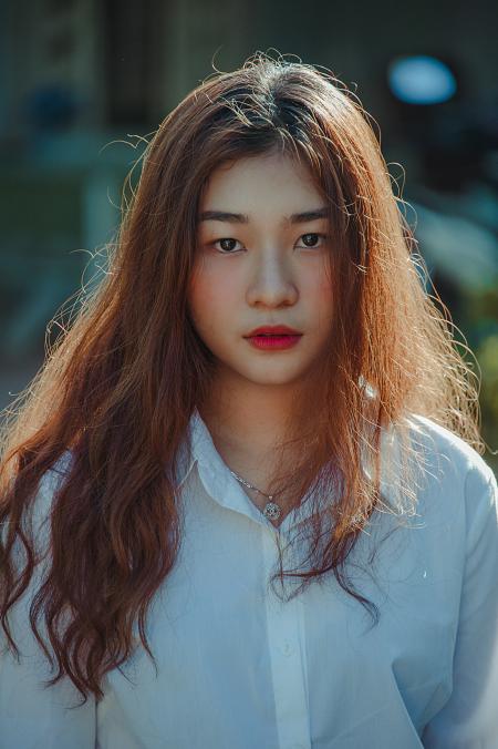 Photo of a Woman Wearing White Collared Long-sleeved Button-up Blouse