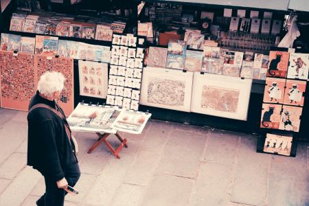 Photo of an Old Man Looking at the Pictures