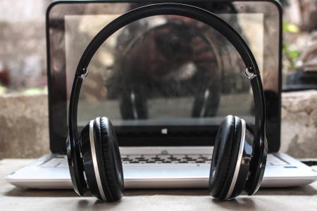 Photo of Black Wireless Headphones in Front of the Laptop