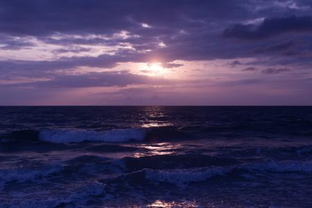 Photo of Blue Ocean and Dark Clouds during Sunset