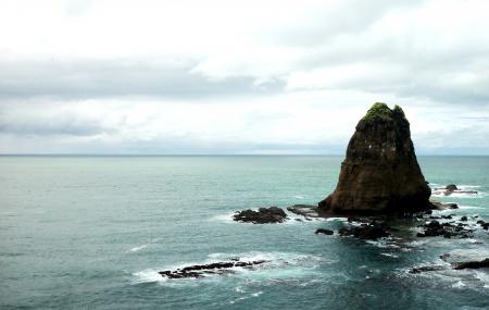 Photo of Brown Rock Formation in Body of Water