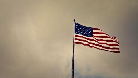 Photo of Cloudy Skies over American Flag