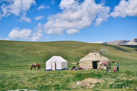 Photo of Hut And Tent On Grass Field