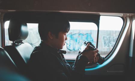 Photo of Man Holding Dslr Camera Looking at Photos