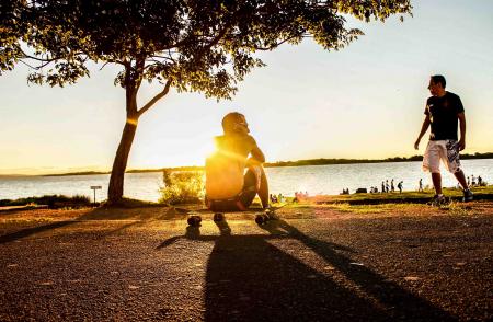 Photo of Man Sitting on Skateboard