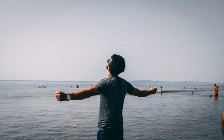 Photo of Man Wearing Gray Shirt Near Sea