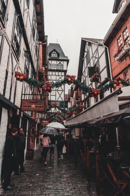 Photo of People Walking Across the Alley