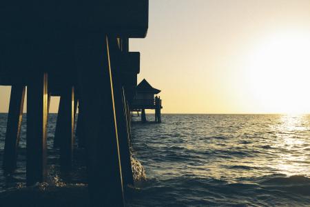 Photo of Pier on Body of Water Under Clear Blue Sky during Daytime