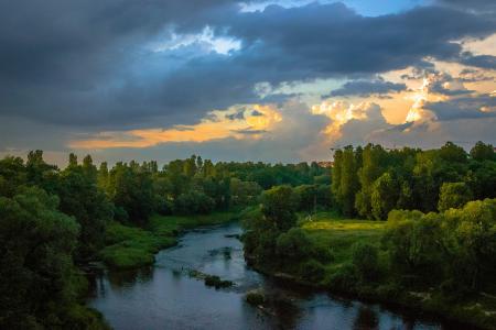 Photo of River Between Green Grass Fields