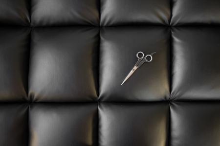 Photo of Scissor on Black Leather Cushion