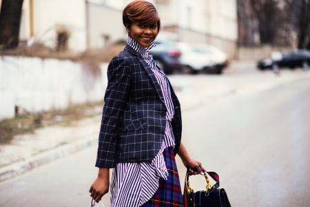 Photo of Woman in Black and Gray Blazer Holding Bag