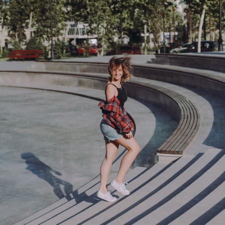 Photo of Woman in Black Tank Top Walking on Stairs at a Park