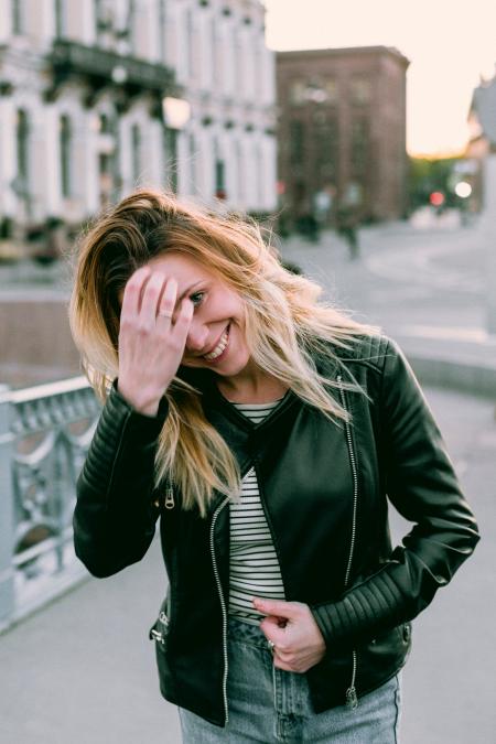 Photo of Woman Wearing Black Zip-up Leather Jacket and White and Black Striped Shirt