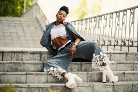 Photo of Woman Wearing Blue Blazer and Blue Pants on Stairs