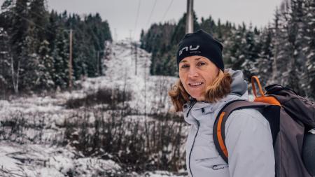 Photo of Woman Wearing Gray Windbreaker Jacket Carrying Backpack