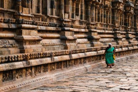 Photo of Woman Wearing Teal Traditional Dress Walking Along Pavement