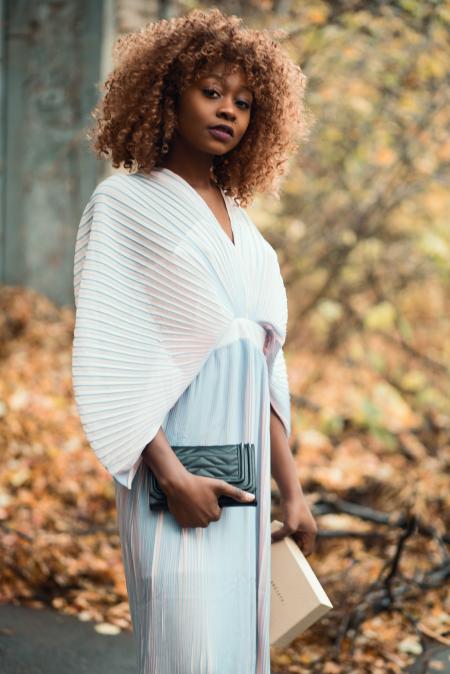 Photo of Woman Wearing White Dress and Holding Black Purse