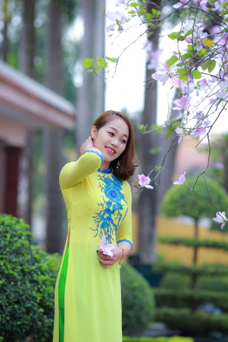 Photo of Woman Wearing Yellow and Blue Floral 3/4-sleeved Dress