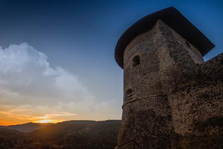 Photograph of Brown Temple Near Mountains during Sunset