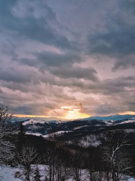 Photograph Of Snow Covered Mountains During Sunrise