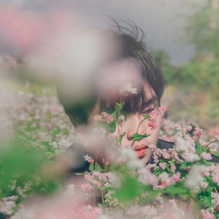 Photography of A Man Near Flowers