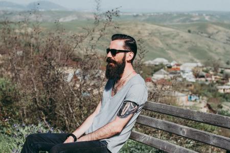 Photography of a Man Sitting on Wooden Bench