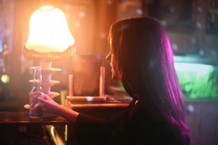 Photography of a Woman Holding Beer Bottle