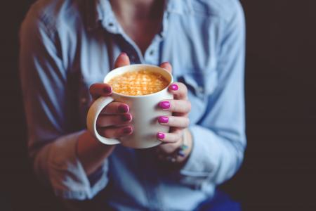 Photography of A Woman Holding White Coffee Mug