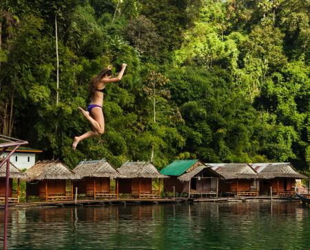 Photography of a Woman Jumping Into The Water