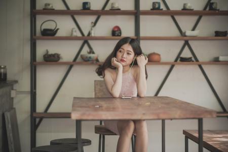 Photography of a Woman Sitting on The Chair Listening to Music