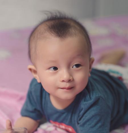 Photography of Cute Baby Laying on the Bed