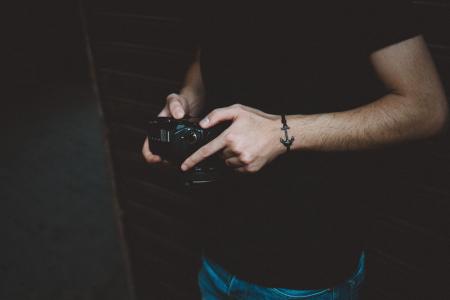 Photography of Man Holding Dslr Camera