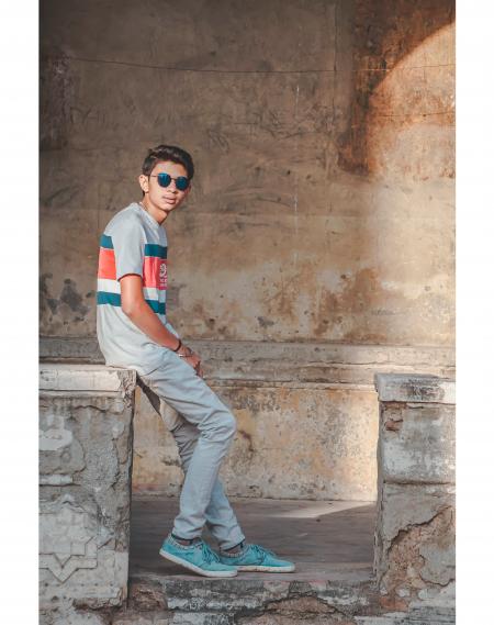 Photography of Man Sitting on Stone