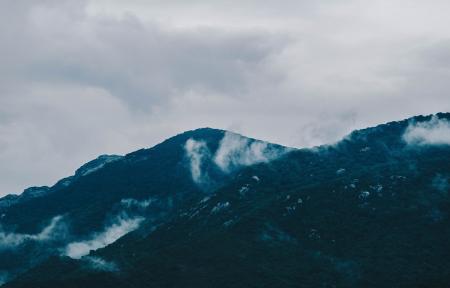 Photography of Mountain Under Cloudy Sky