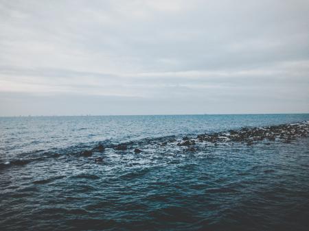 Photography of Ocean Under Cloudy Sky