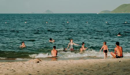 Photography of People Swimming in the Beach