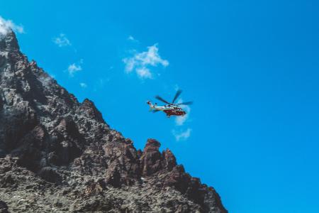 Photography of White and Red Helicopter Flying