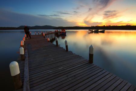 Pier over Sea Against Sky during Sunset