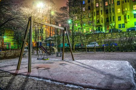 Playground Surrounded With Buildings And Cars