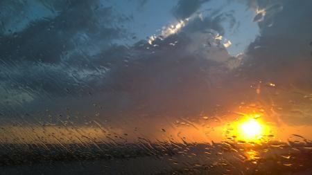 Rain on a window at sunset
