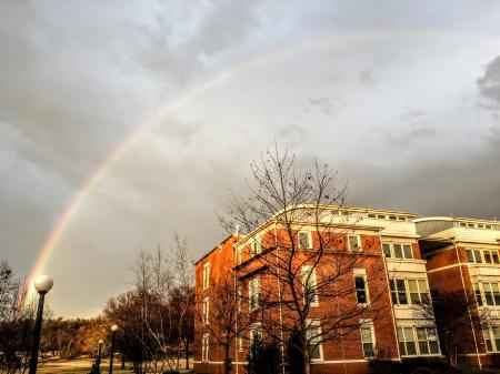 Rainbow Appear Above Brown and White Concrete Building