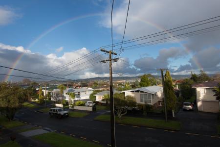 Rainbow in residential neighborhood in Avondale, Auckland