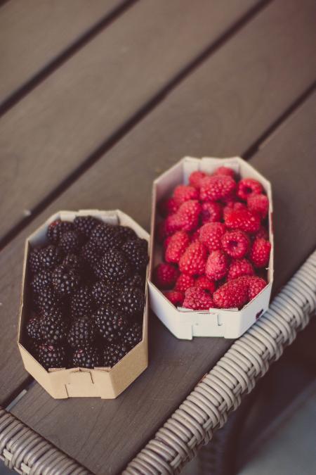 Raspberries And Blueberries On Top Of Table