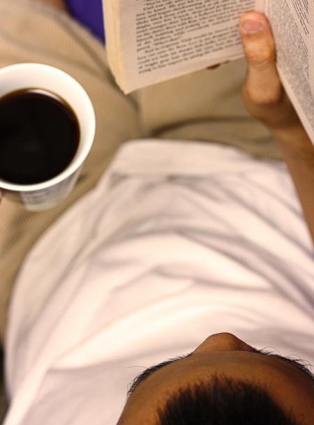 Reading A Book And Drinking A Cup Of Coffee