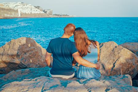 Rear View of Couple Sitting on Beach