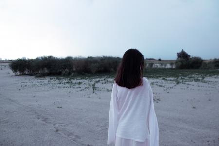 Rear View of Woman Standing on Beach